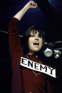 Actress Jane Fonda performing antiwar skit with a sign reading 'Enemy'. She and several other entertainers put together skits with a radical spin and tried to stage them. They ended up in a local GI coffeehouse. (Photo by Bill Ray/The LIFE Picture Collection via Getty Images)