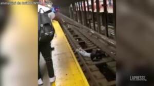 New York, cade sui binari della metro: poliziotto lo salva prima dell’arrivo del treno