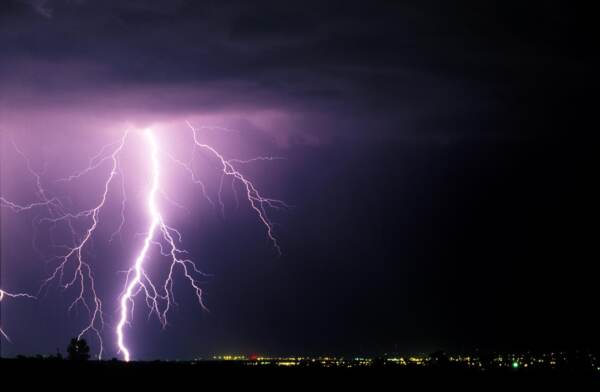 A LARGE LIGHTING BOLT LIGHTS UP THE SKY AS IT STRIKES NEAR FORT COLLINS COLORADO.