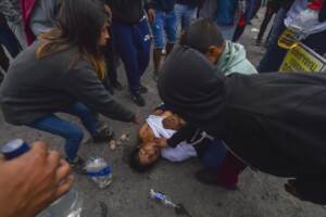 Protests move into Peru’s capital, met by tear gas and smoke