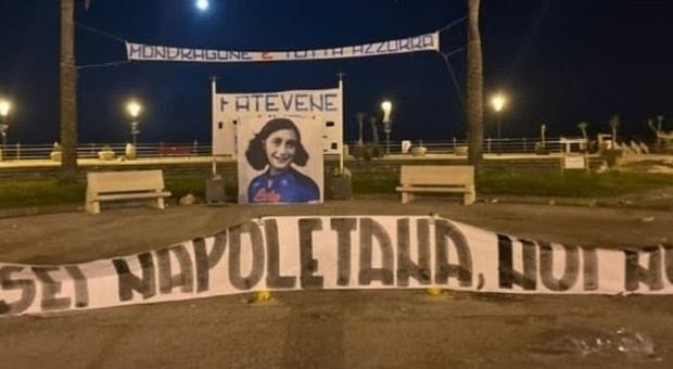 Scudetto Napoli, striscione schock a Mondragone: Anna Frank con maglia azzurra Scudetto Napoli, striscione schock a Mondragone: Anna Frank con maglia azzurra