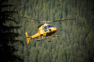 AN A STAR HELICOPTER, OPERATED BY TALON HELICOPTERS, APPROCHES A LANDING ZONE IN THE COAST MOUNTAINS.
