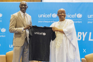 TikTok star Khaby Lame receives a T-shirt from UNICEF Regional Director for West and Central Africa Gilles Fagninou after being named UNICEF Goodwill Ambassador Friday, Jan. 31, 2025 in Dakar, Senegal. (AP Photo/Sylvain Cherkaoui)