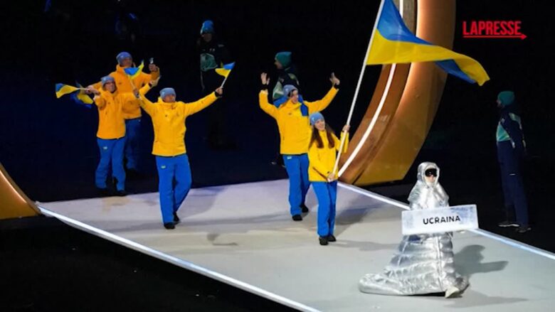 Olimpiadi 2026,  è una donna russa quella che ha portato il cartello con scritto 'Ucraina' alla cerimonia di apertura